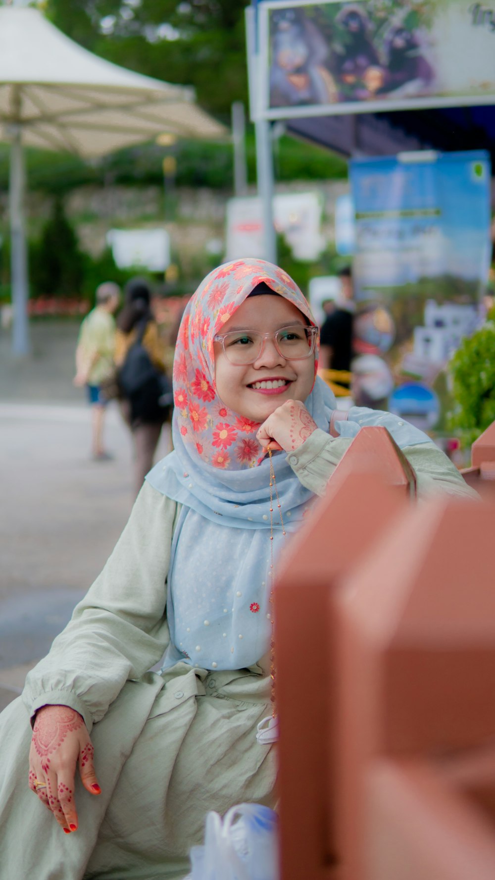 a woman in a hijab sitting on a bench