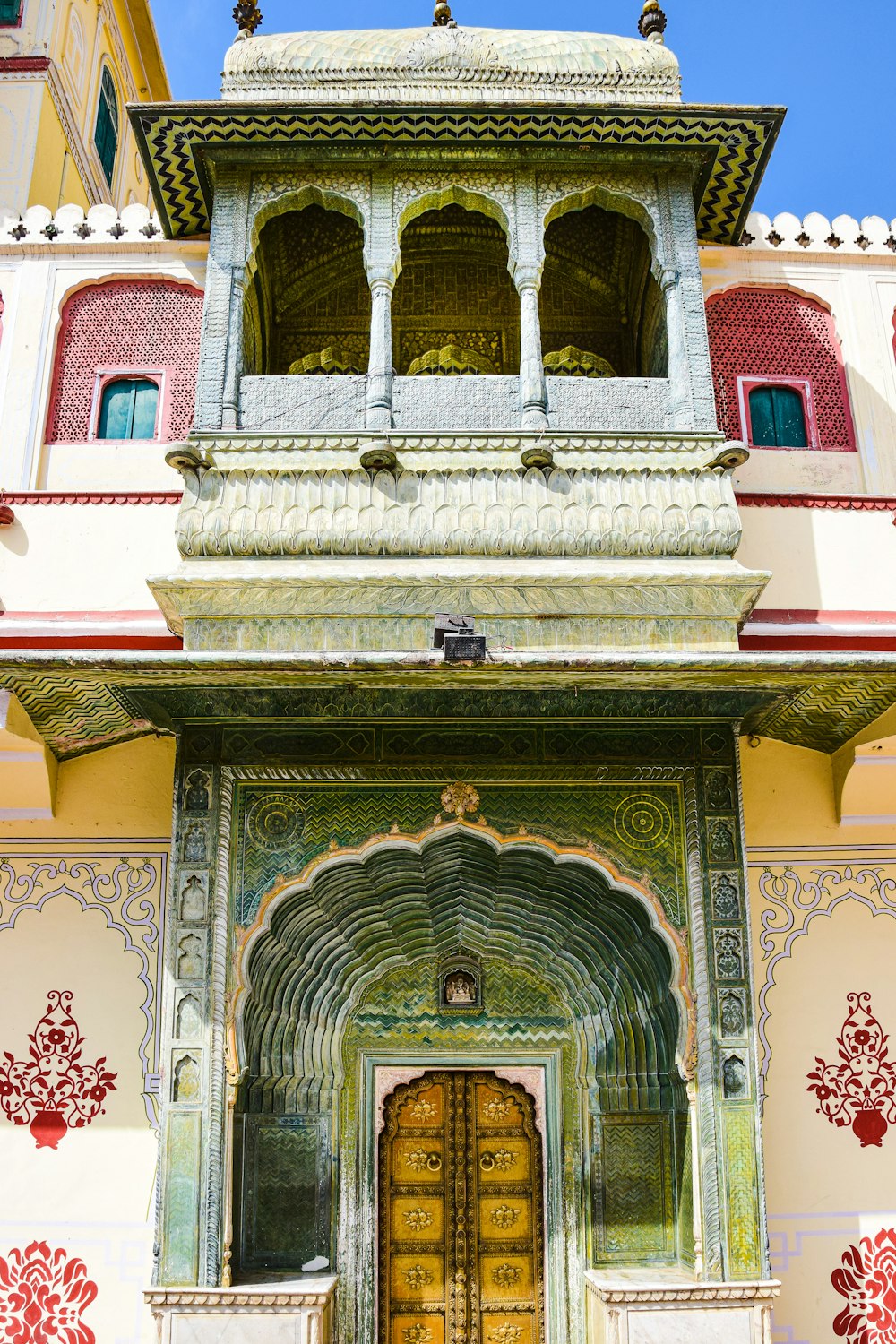 a large building with a yellow door and a red and white wall