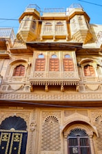 a tall building with many windows and balconies