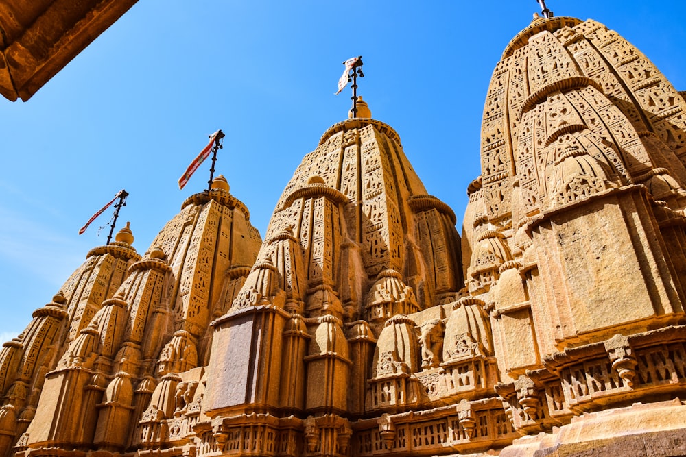 a row of ornately carved buildings with a blue sky in the background