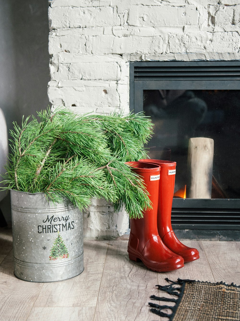 a pair of red boots sitting next to a christmas tree