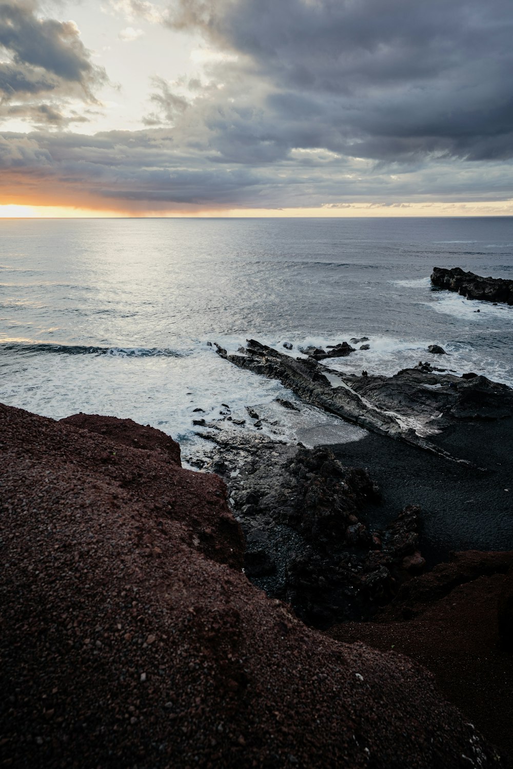 a view of the ocean from a rocky shore