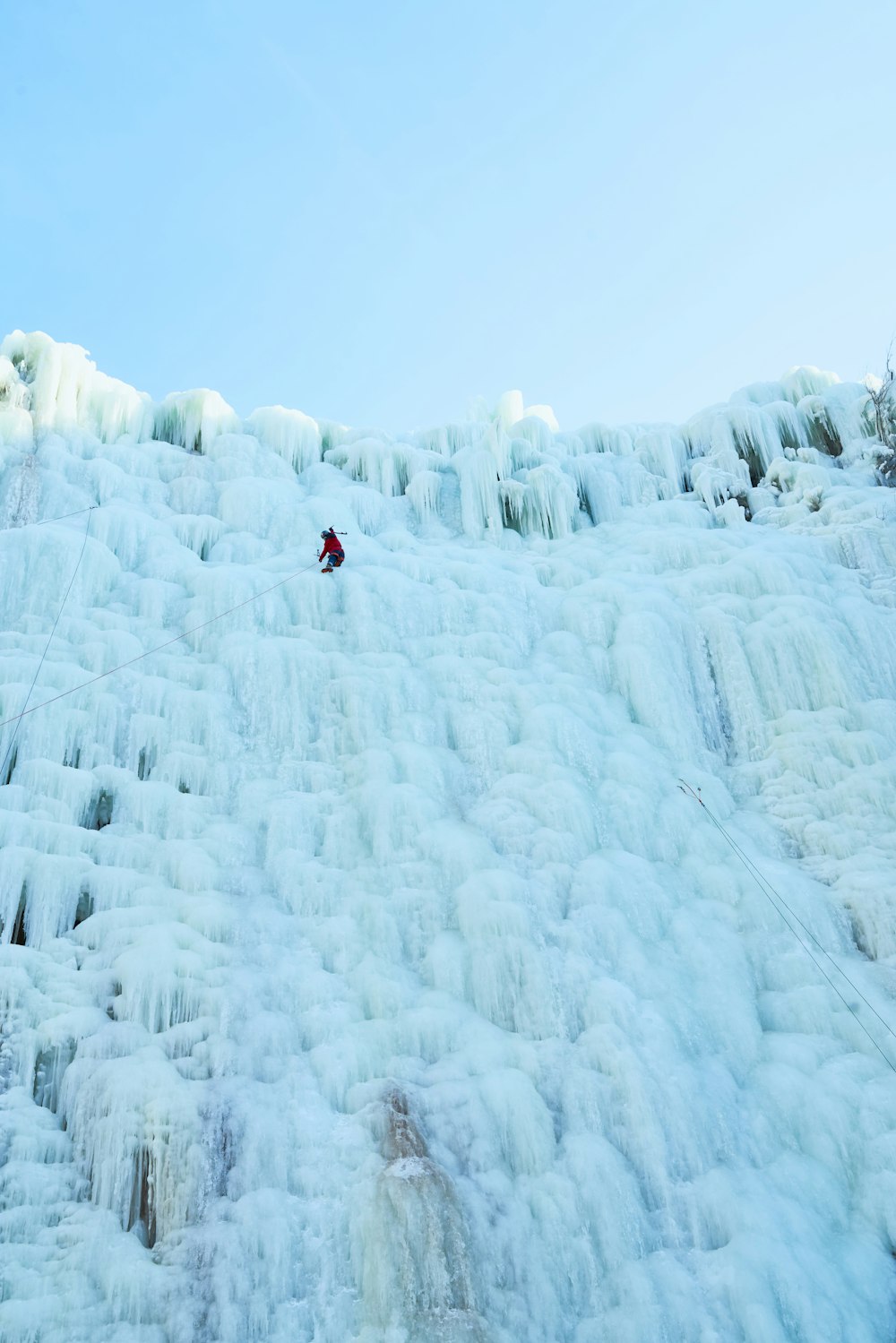 a man is skiing down a frozen waterfall