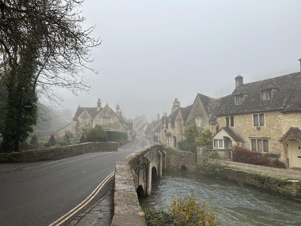 a river running through a village next to a bridge