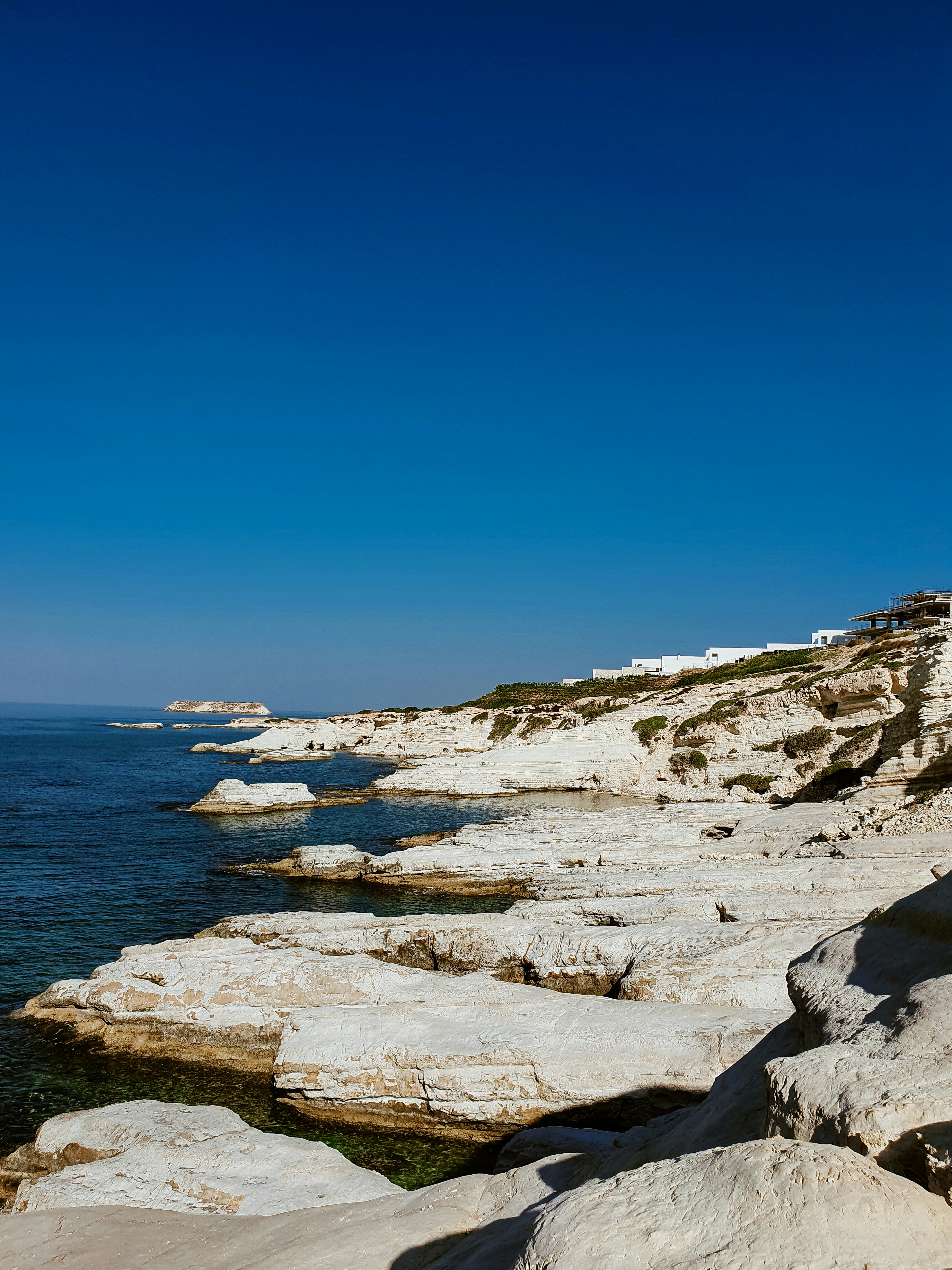 a rocky shoreline with a lighthouse on top of it