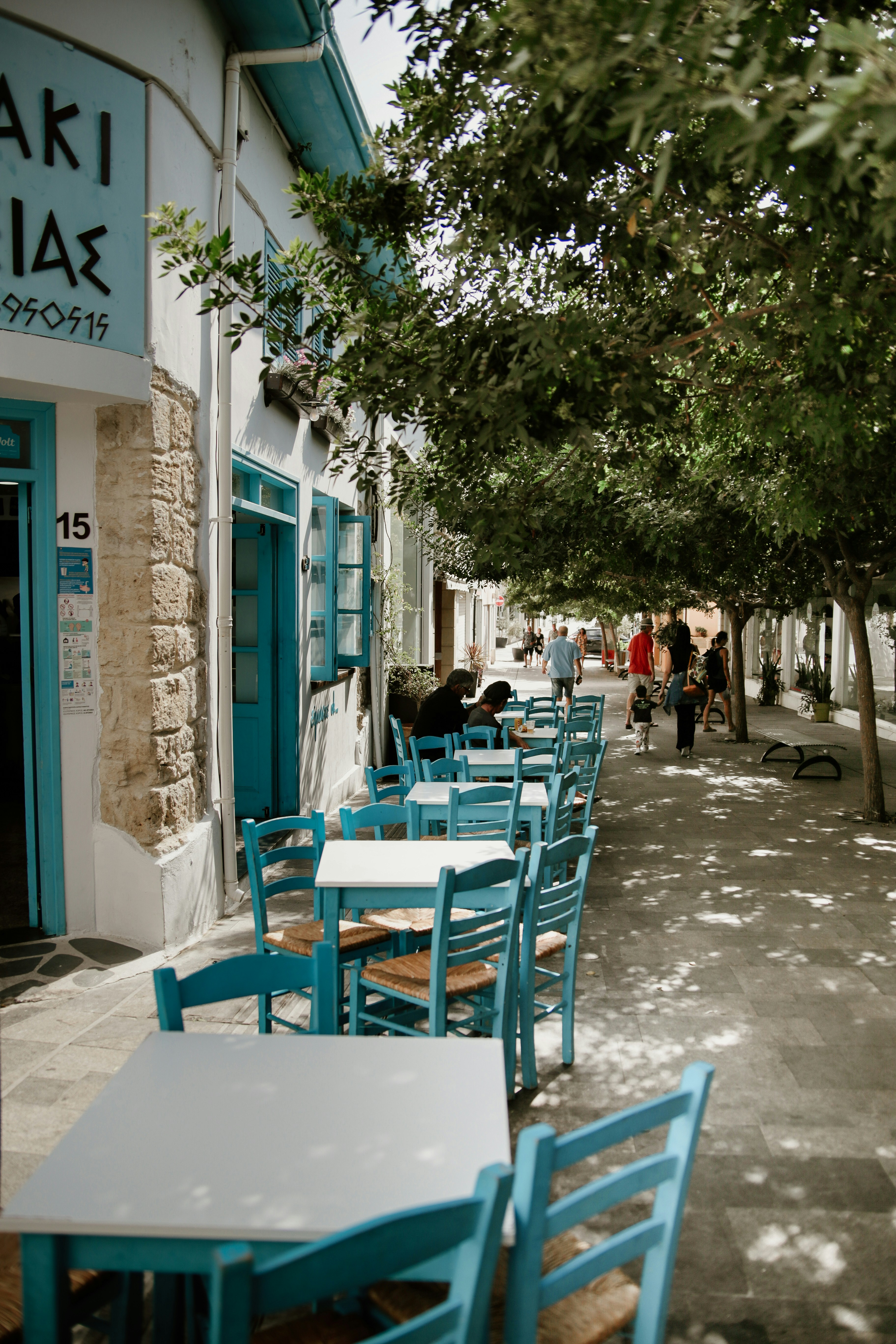 a row of tables and chairs on a sidewalk