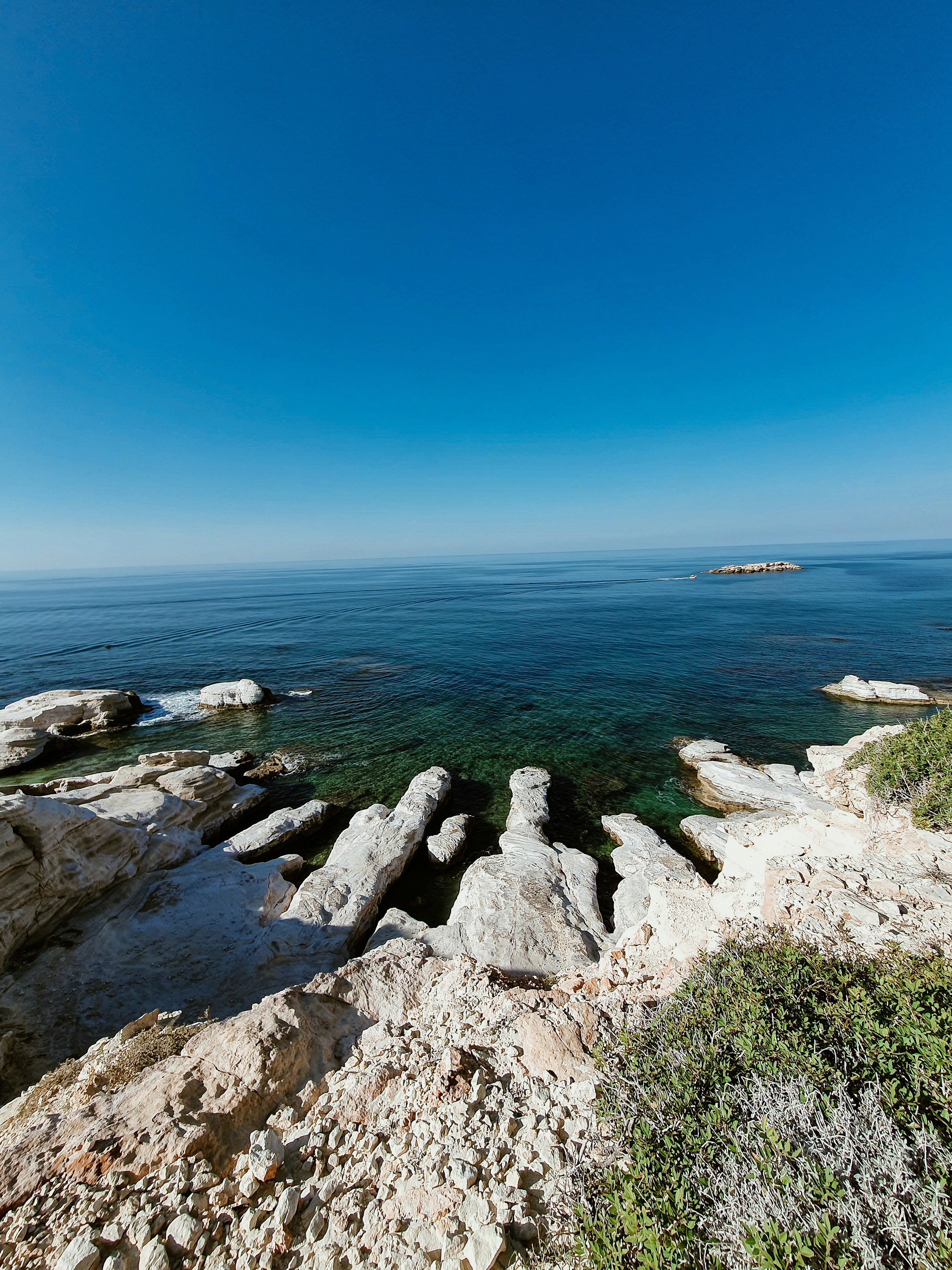 a view of the ocean from a rocky shore