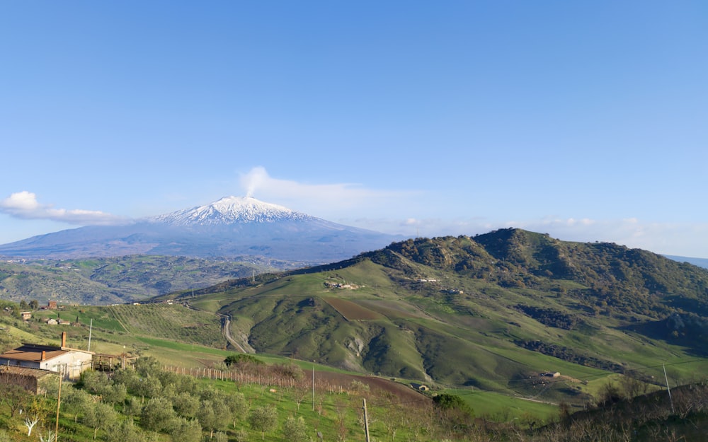 a view of a mountain range with a house in the foreground