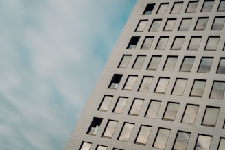 Modern office building with abstract geometric patterns in the background.