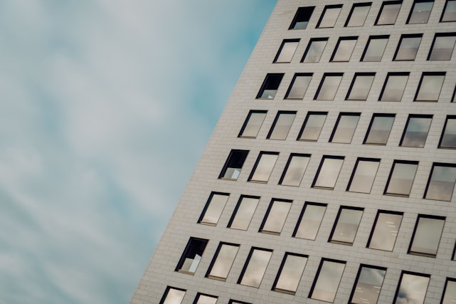 Modern office building with abstract geometric patterns in the background.