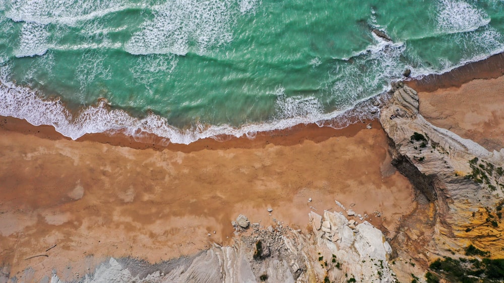 an aerial view of a sandy beach and ocean