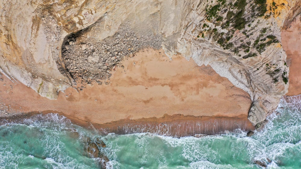 an aerial view of the ocean and cliffs
