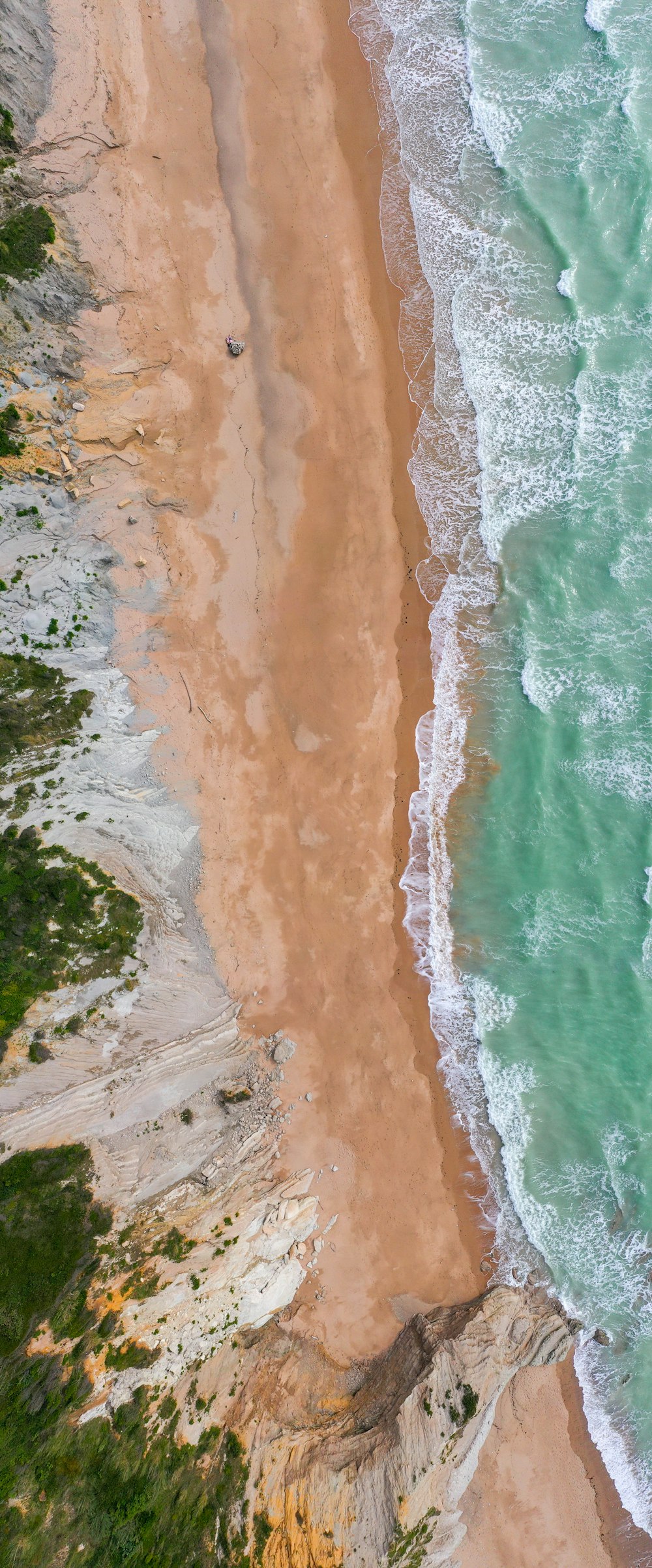 a bird's eye view of a beach and ocean