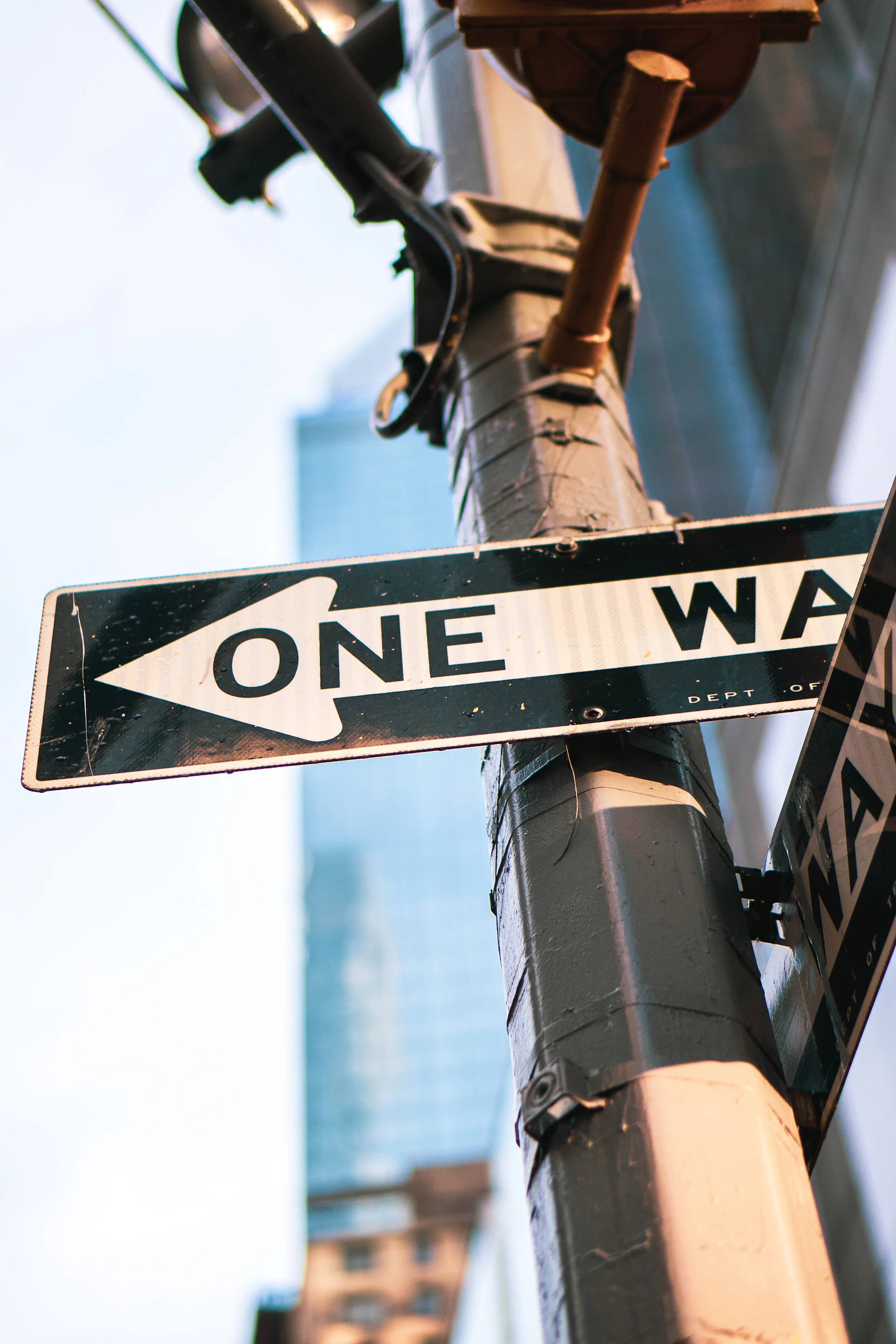 a one way street sign on a pole