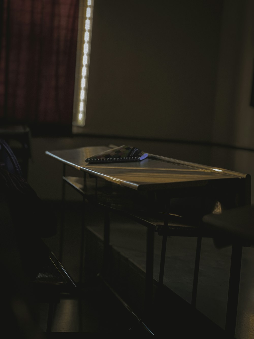 a table and a chair in a dark room