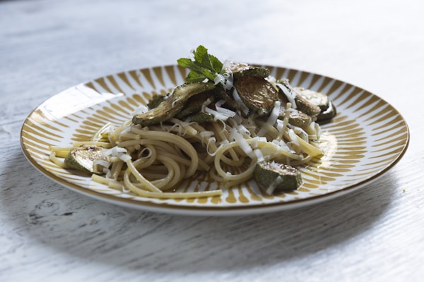 A plate of pasta with mushrooms and parmesan cheese