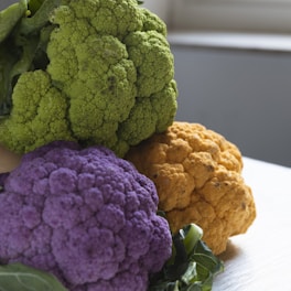 a bunch of different colored cauliflower on a table