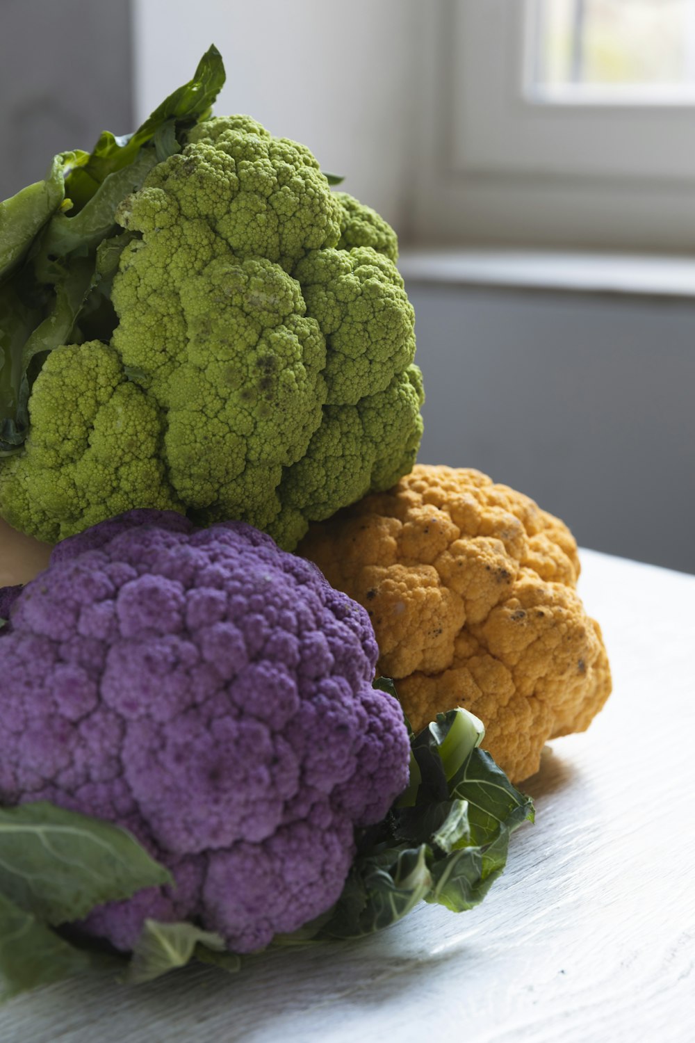 a bunch of different colored cauliflower on a table
