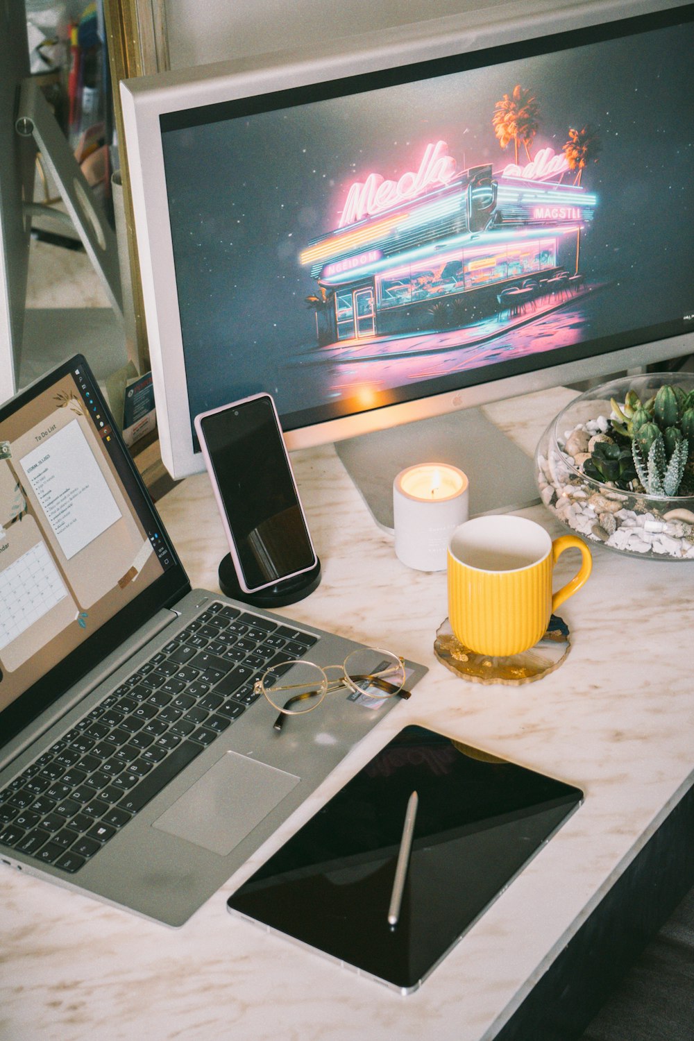 a laptop computer sitting on top of a desk