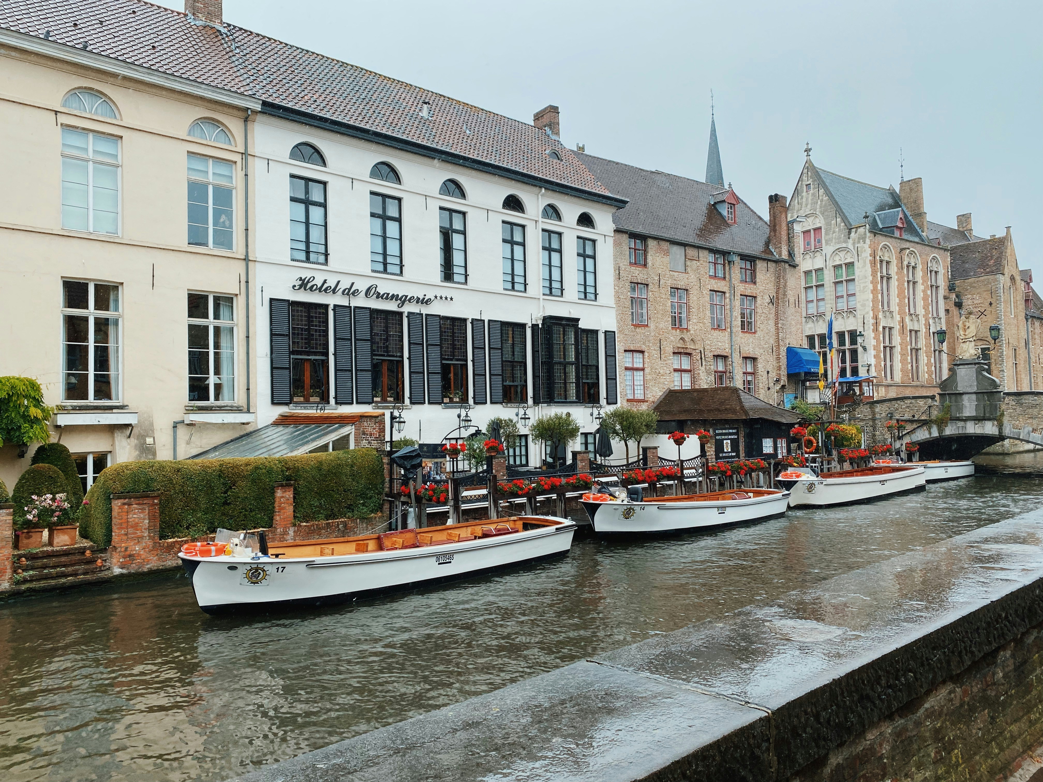 a row of boats sitting next to each other on a river