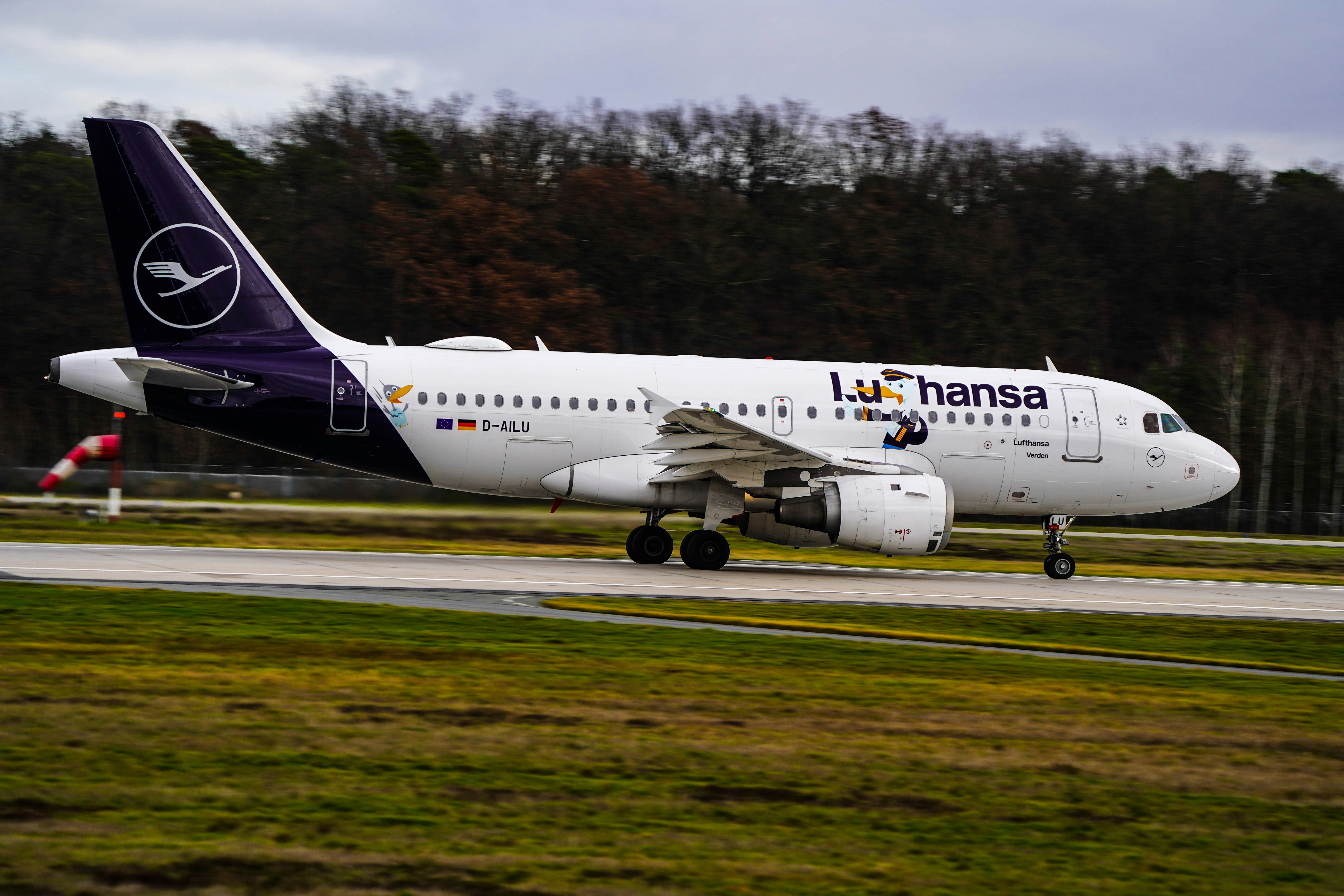 a large jetliner sitting on top of an airport runway, 