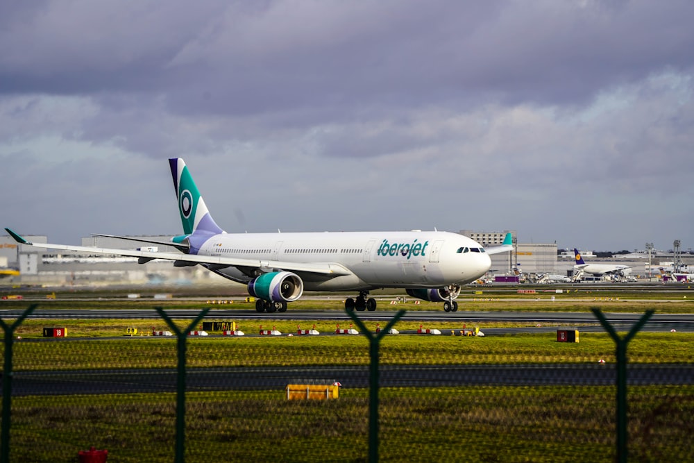 a large jetliner sitting on top of an airport runway