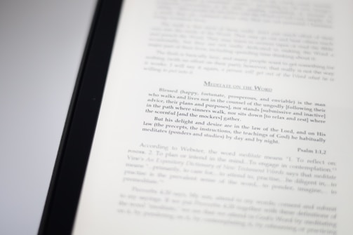 A close-up image of a book page with text focusing on meditation and scriptural interpretation. The text is primarily in black font, with some headings in a larger or bold type. The page is well-lit, capturing the details of the printed words.