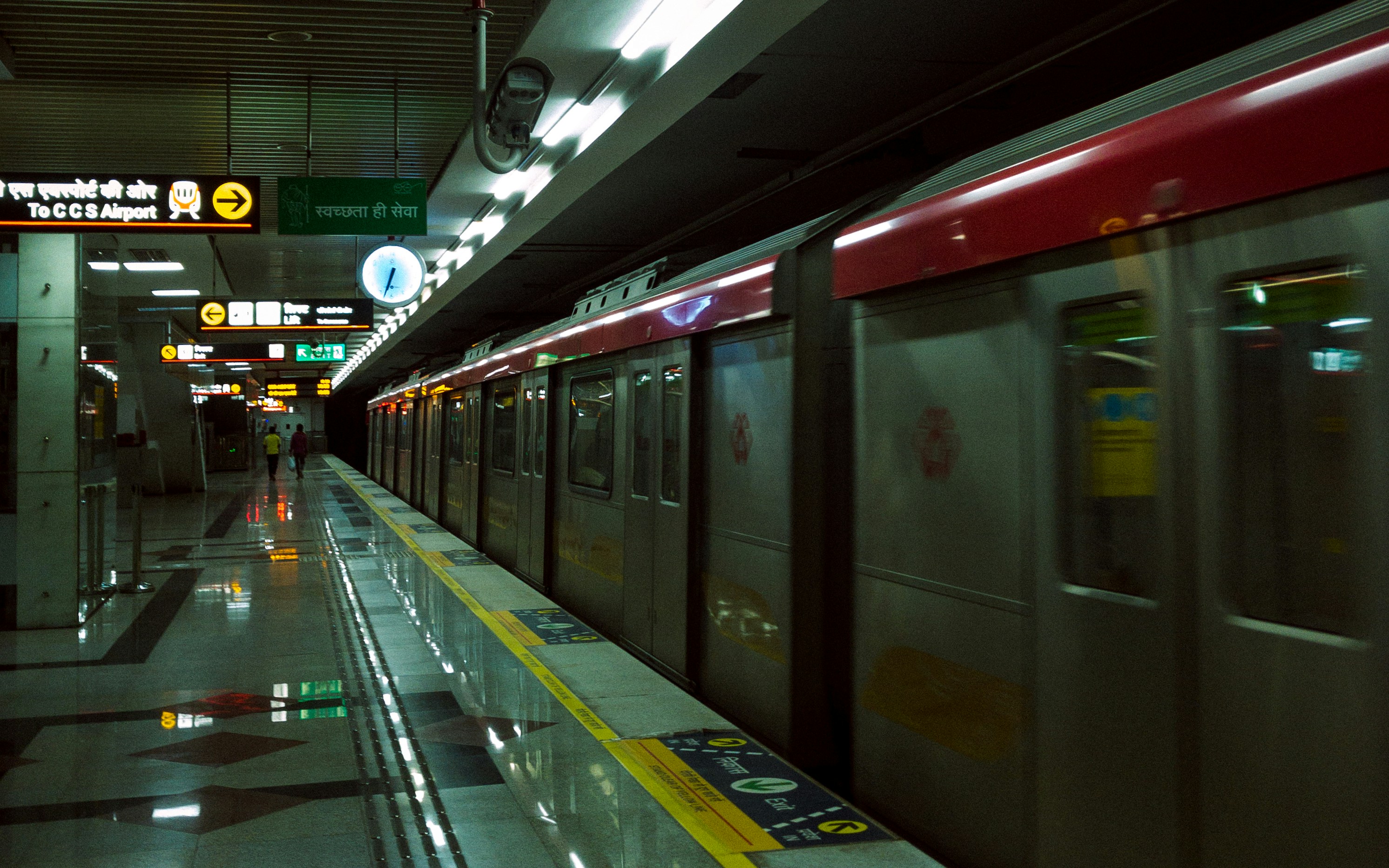 a subway train pulling into a train station