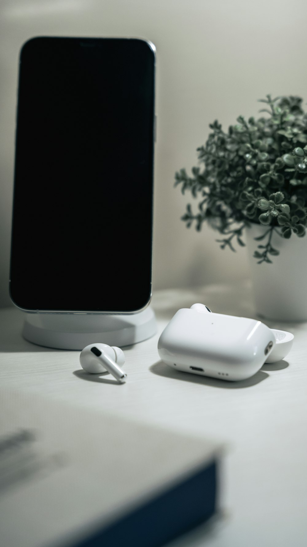 a cell phone and ear buds on a table