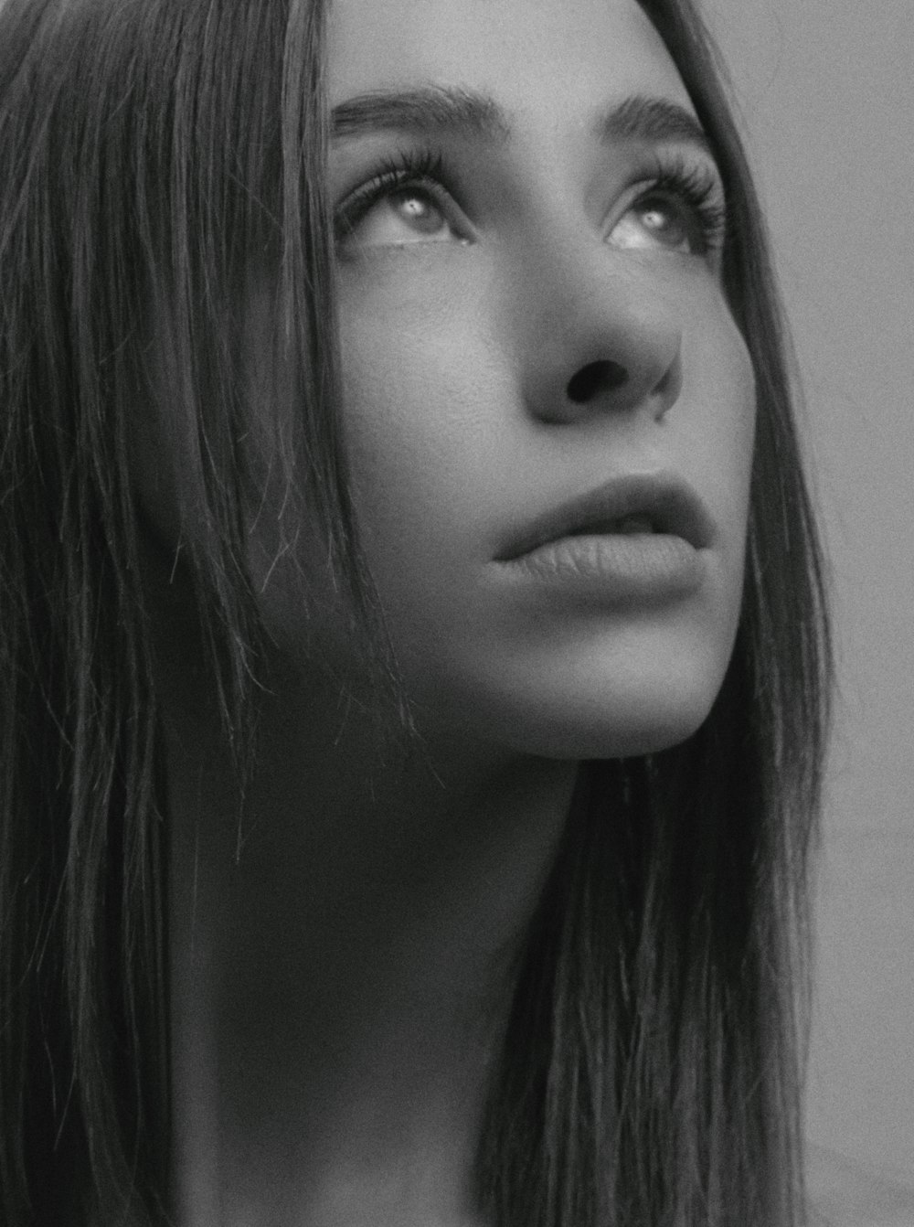 a black and white photo of a woman with long hair