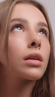 A model showcasing a natural makeup look in soft lighting.