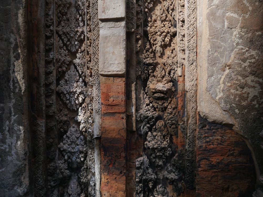 a close up of a stone wall with a clock on it