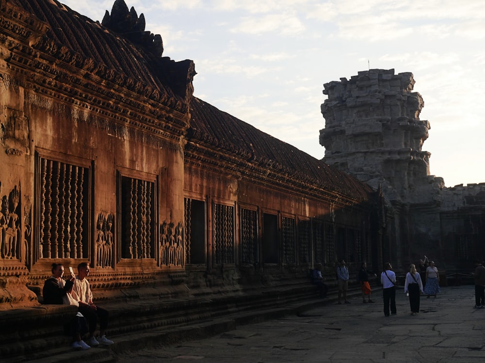 a group of people standing around a building