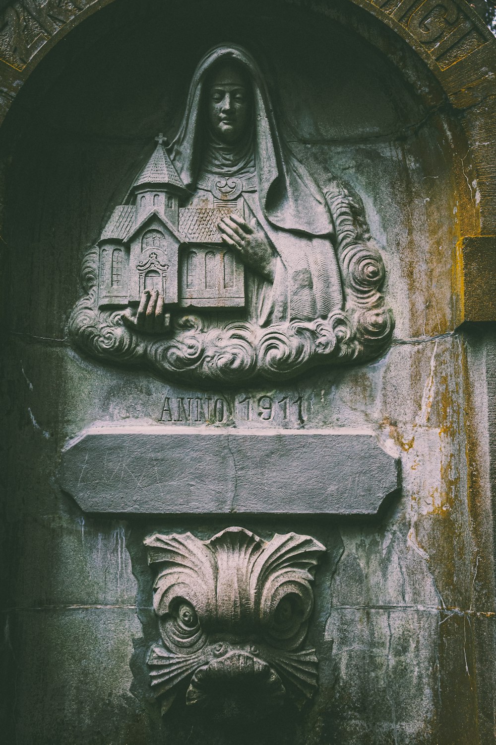 a statue of a woman with a house on her head