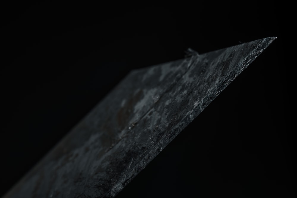 a close up of a piece of metal with a black background