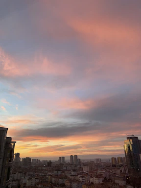 A serene Melbourne cityscape at dusk with warm golden light reflecting off modern buildings.