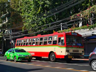 A group sightseeing tour in a classic taxi passing lush green landscapes and colorful markets.