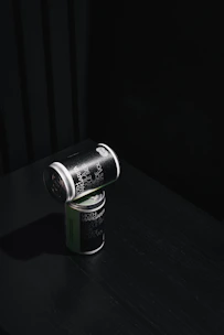 Minimalist industrial-style product shot of Fugaz nutritional bars and shakes on a dark gray background with vibrant red accents.