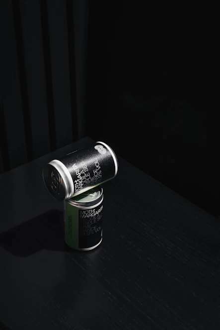 Minimalist industrial-style product shot of Fugaz nutritional bars and shakes on a dark gray background with vibrant red accents.