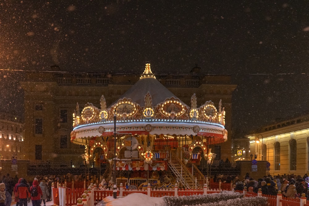 a merry go round in the snow at night