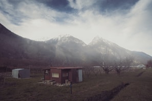 A cozy ham radio station nestled in a rustic Montana cabin with mountains visible through the window
