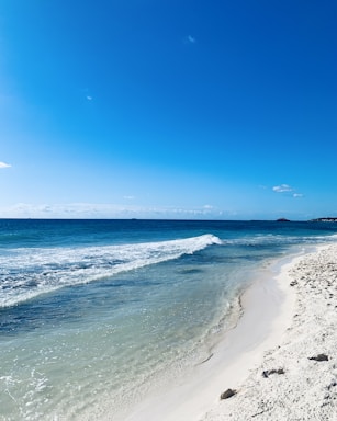 A serene beach view in Okinawa with clear blue skies.