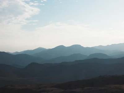 Soft focus image of a serene mountain landscape under a clear blue sky.