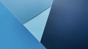 Abstract blue and grey geometric shapes forming a modern tech pattern.