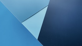Abstract blue and grey geometric shapes forming a modern tech pattern.