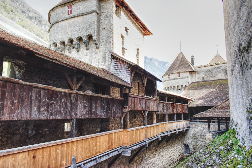 a wooden walkway leading to a building with a clock tower in the background