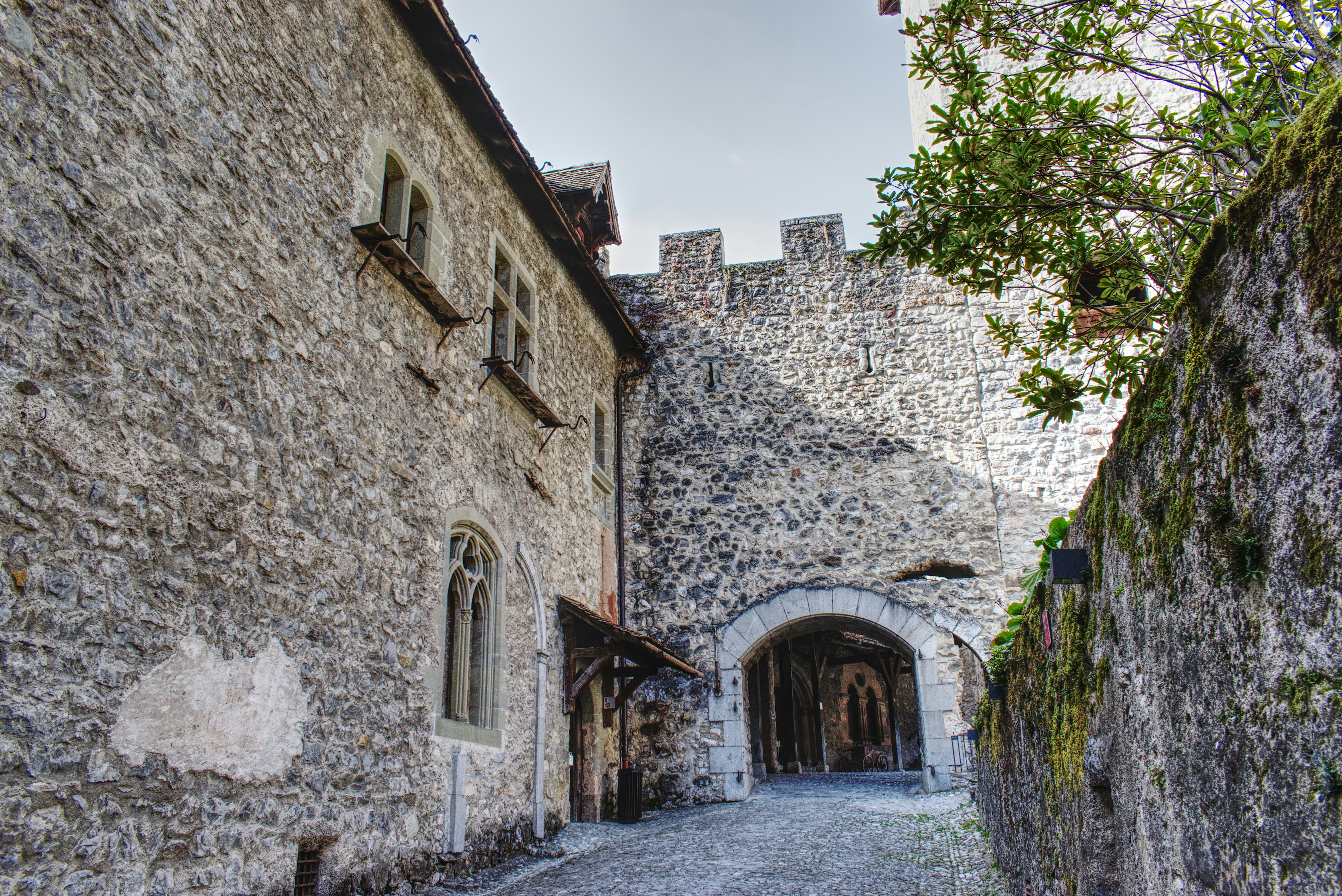 a stone building with a stone walkway between it