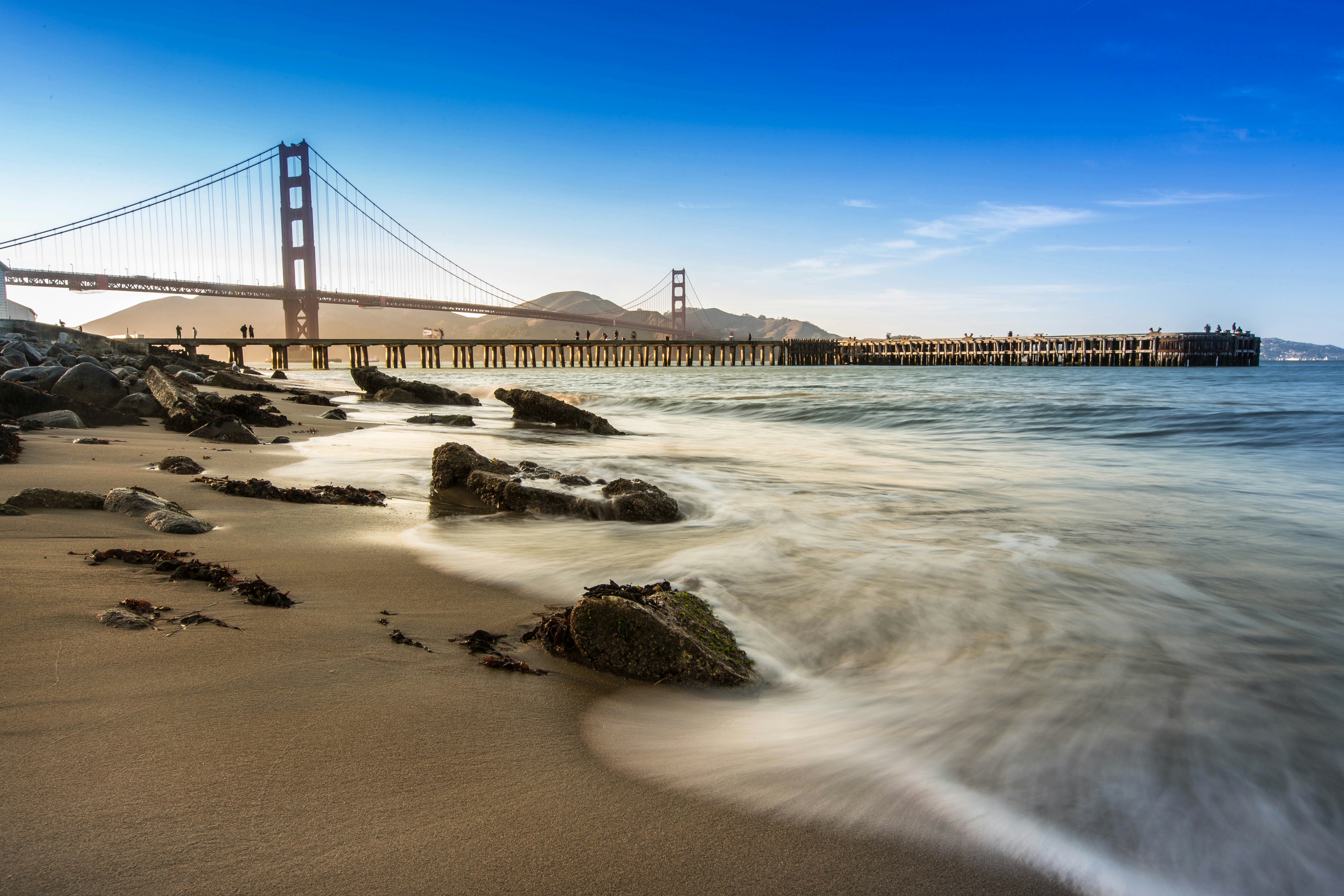 a view of the golden gate bridge from the beach