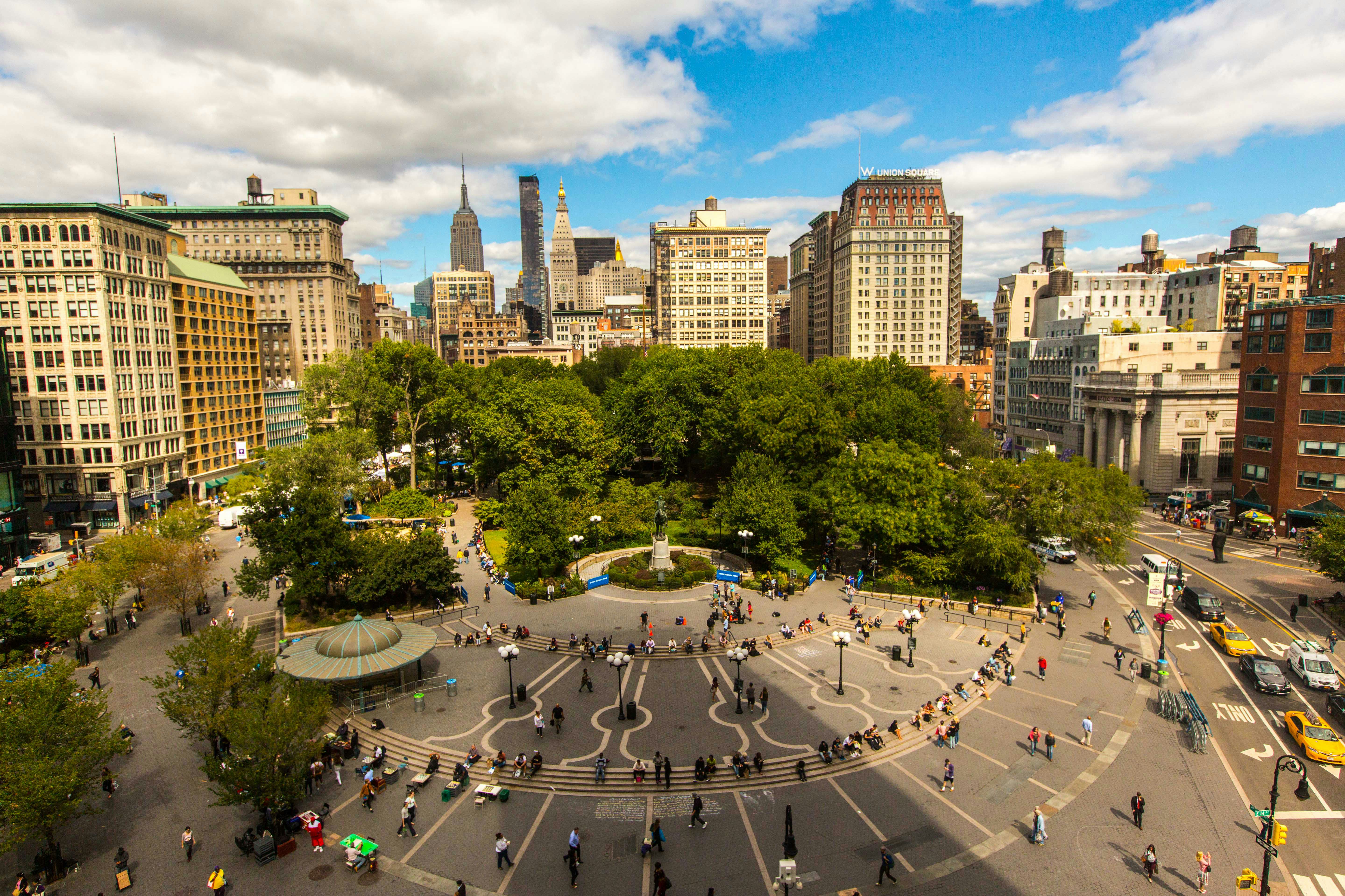 an aerial view of a city square with people walking around