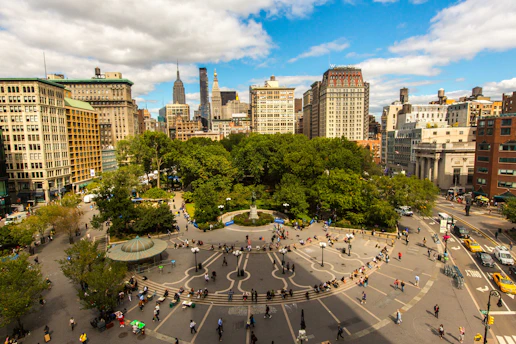 an aerial view of a city square with people walking around